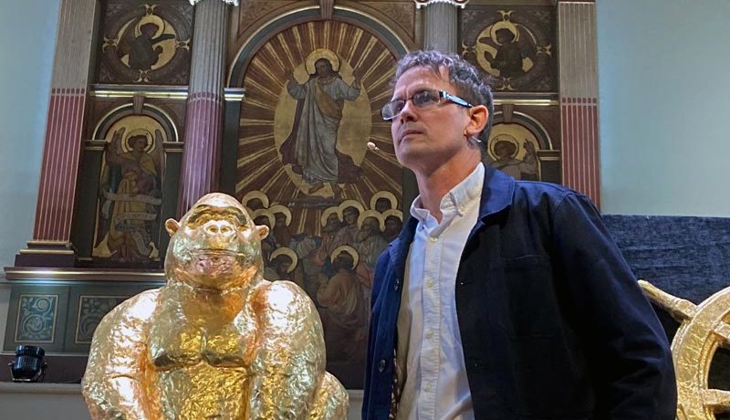 Artist Luke Jerram with a large gold-foiled chocolate version of Alfred the gorilla